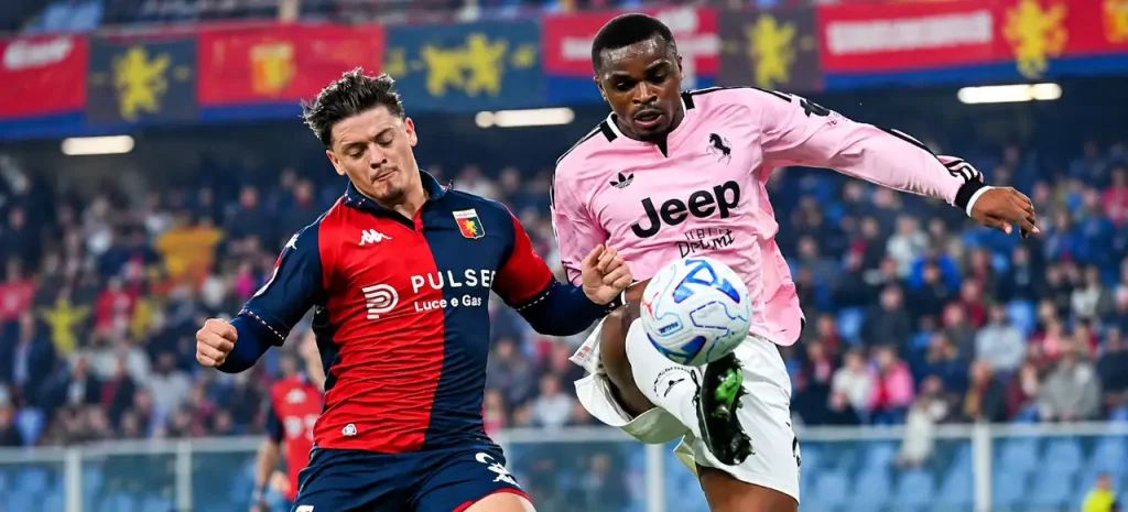 Giocatore della Juventus in maglia rosa con scritta Jeep controlla il pallone contrastato da un avversario del Genoa in